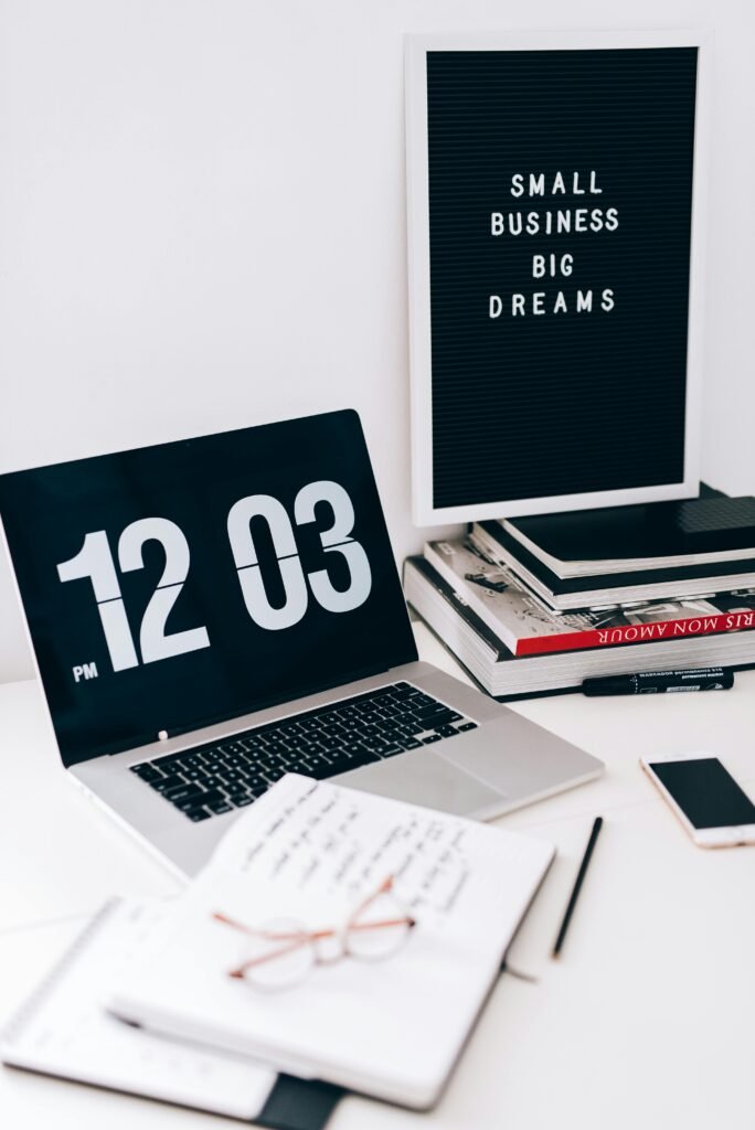 Stylish workspace with a laptop, letter board, and stationery for a creative and productive environment.